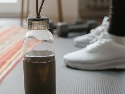 Close-up of a yoga mat and water bottle in a calm setting.